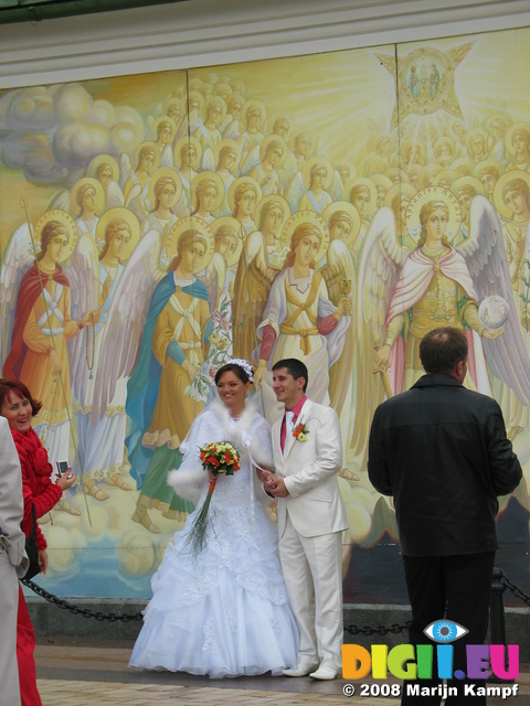 28278 Newly weds by mural at St. Michael's golden domed cathedral